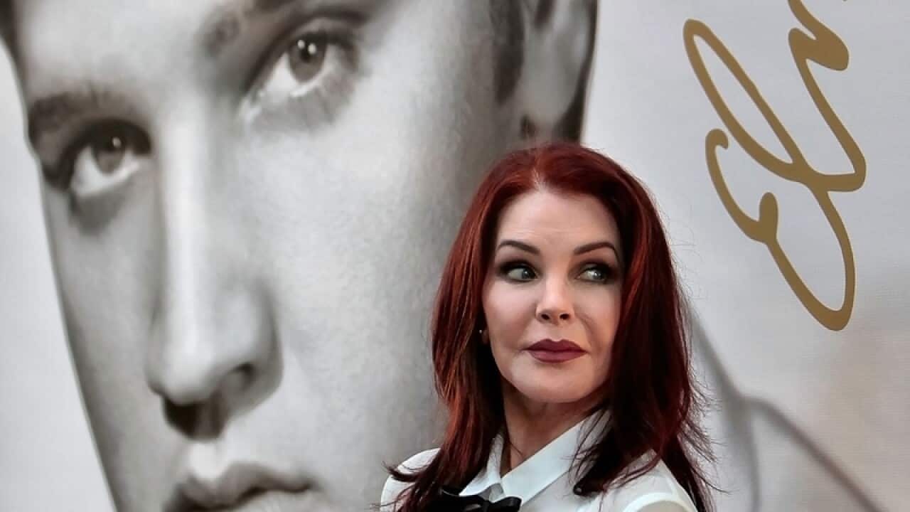 Priscilla Presley glances after a ceremony for the Elvis Forever stamp