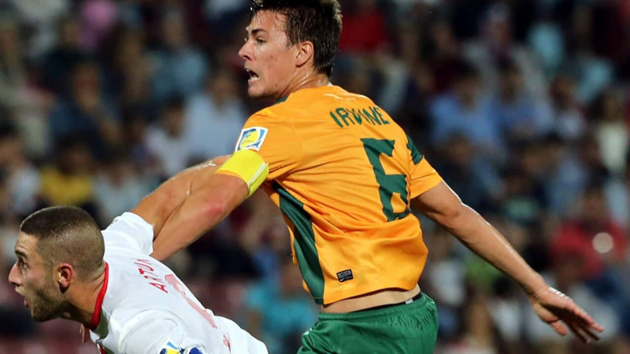 Artun Akcakin (L) of Turkey & Jackson Irvine (R) of Australia