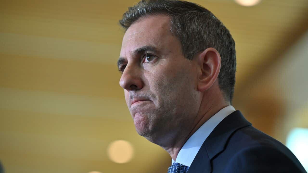 Jim Chalmers in a suit looking off to the side