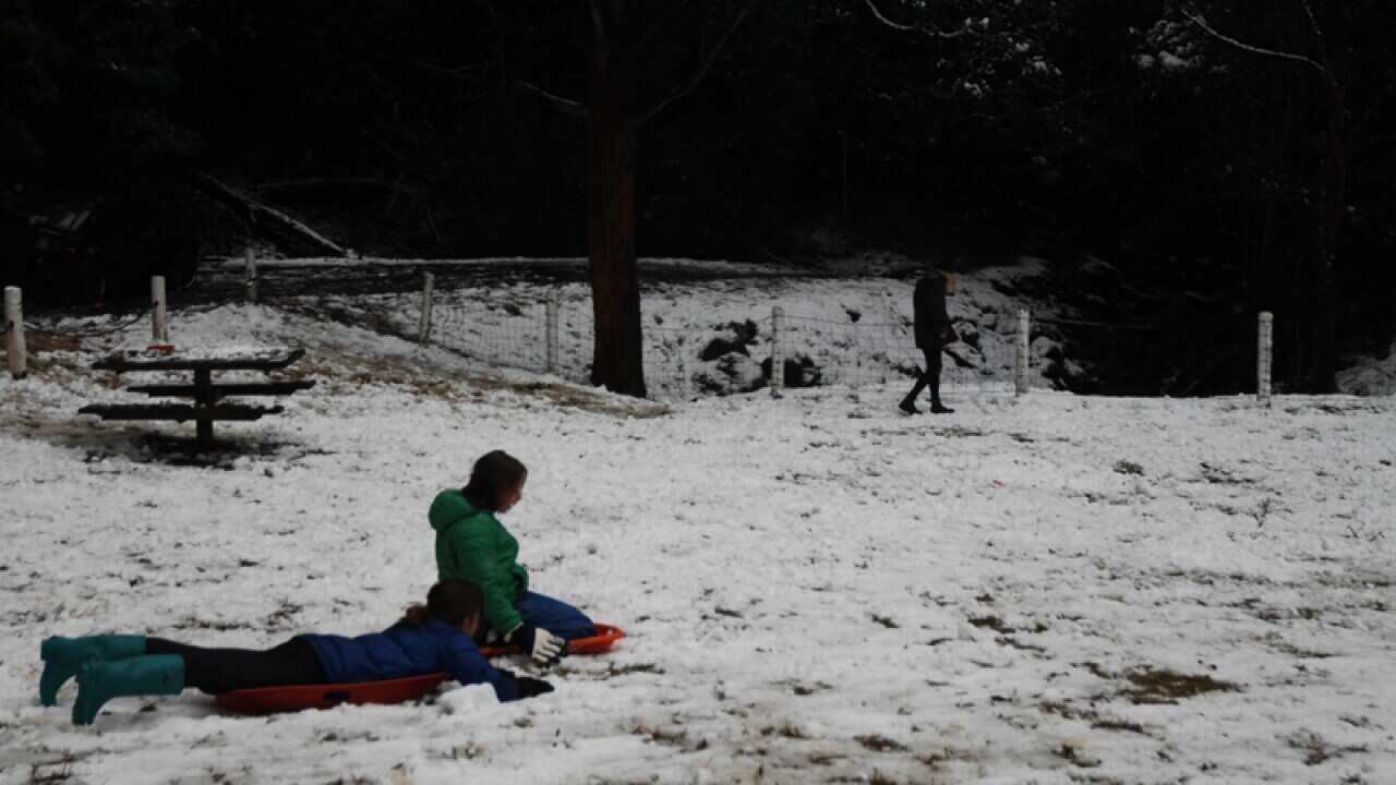 Children play in snow in Tasmania