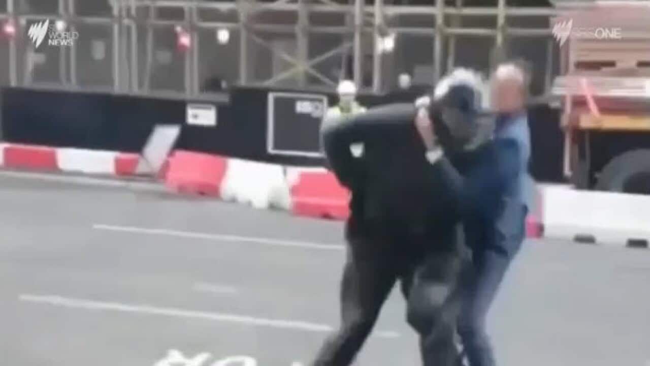 A three robbers fled an upmarket jewellery shop in London's financial district, one of the robbers was pounced upon by a pedestrian. The robber revealed a machete threatening the pedestrian who then retreated.