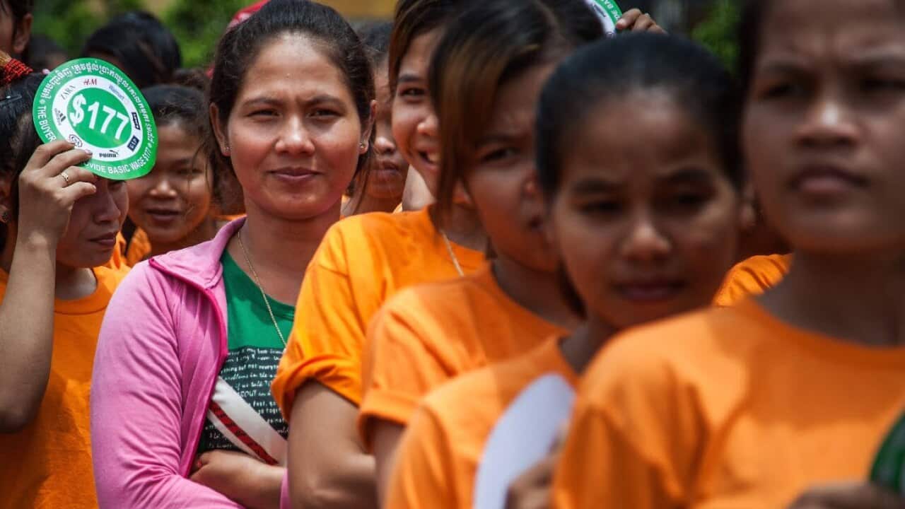 A group of garment workers stand in line inside the Canadia Industrial Park during a demonstration demanding an increase of their minimum salary on September 17, 2014 in Phnom Penh, Cambodia (Getty)