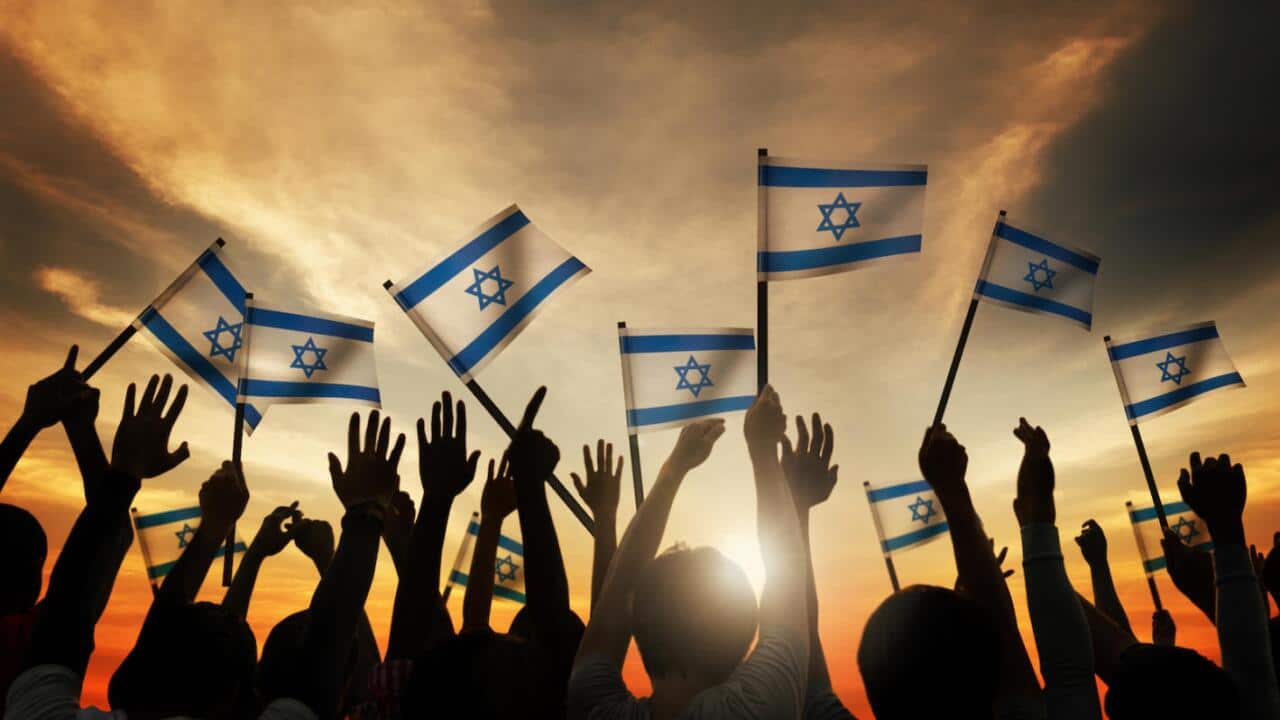 Group of People Waving the Flag of Israel