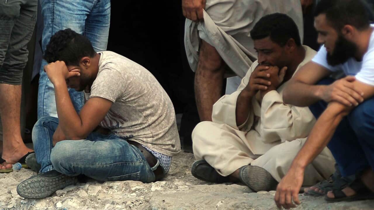 Relatives of missing people wait at the port city of Rosetta