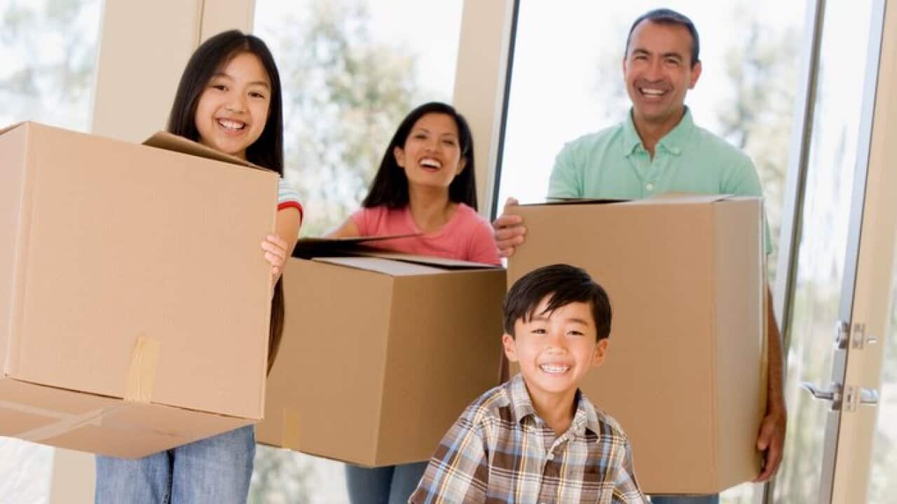 Family moving into new home smiling