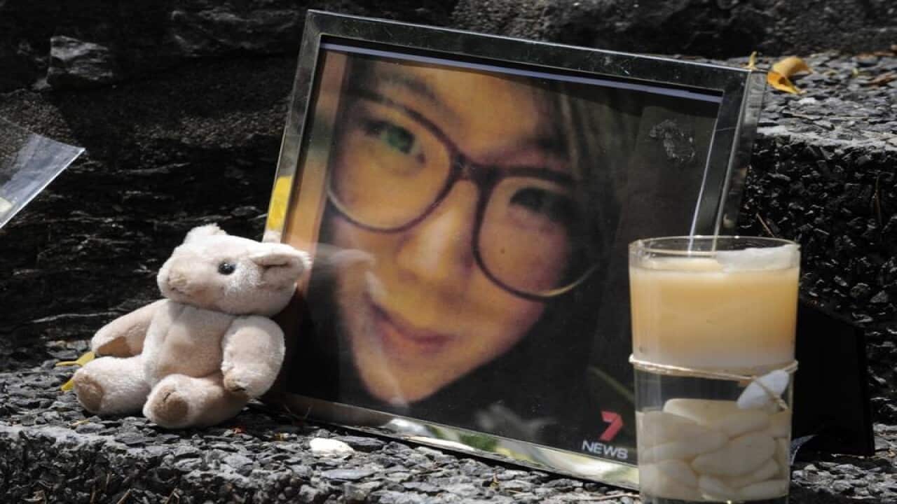 A framed photo of Eunji Ban among tributes near the murder scene