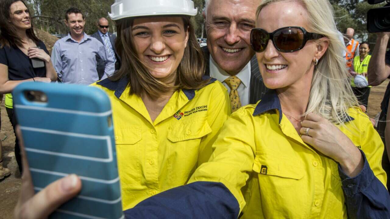 Malcolm Turnbull poses for a selfie with female construction workers