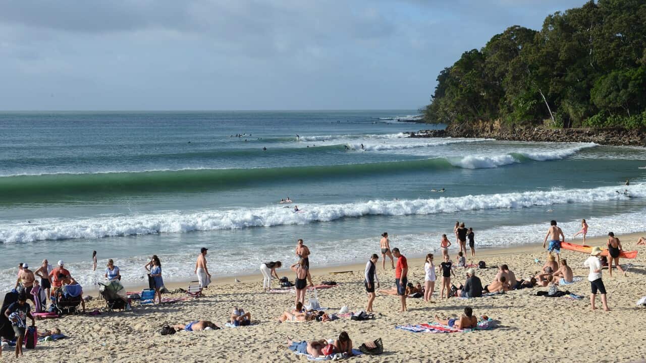 Beachgoers are seen on Noosa Beach in the resort town of Noosa Heads on the Sunshine Coast, Wednesday, July 3, 2013. (AAP Image/Dave Hunt) NO ARCHIVING