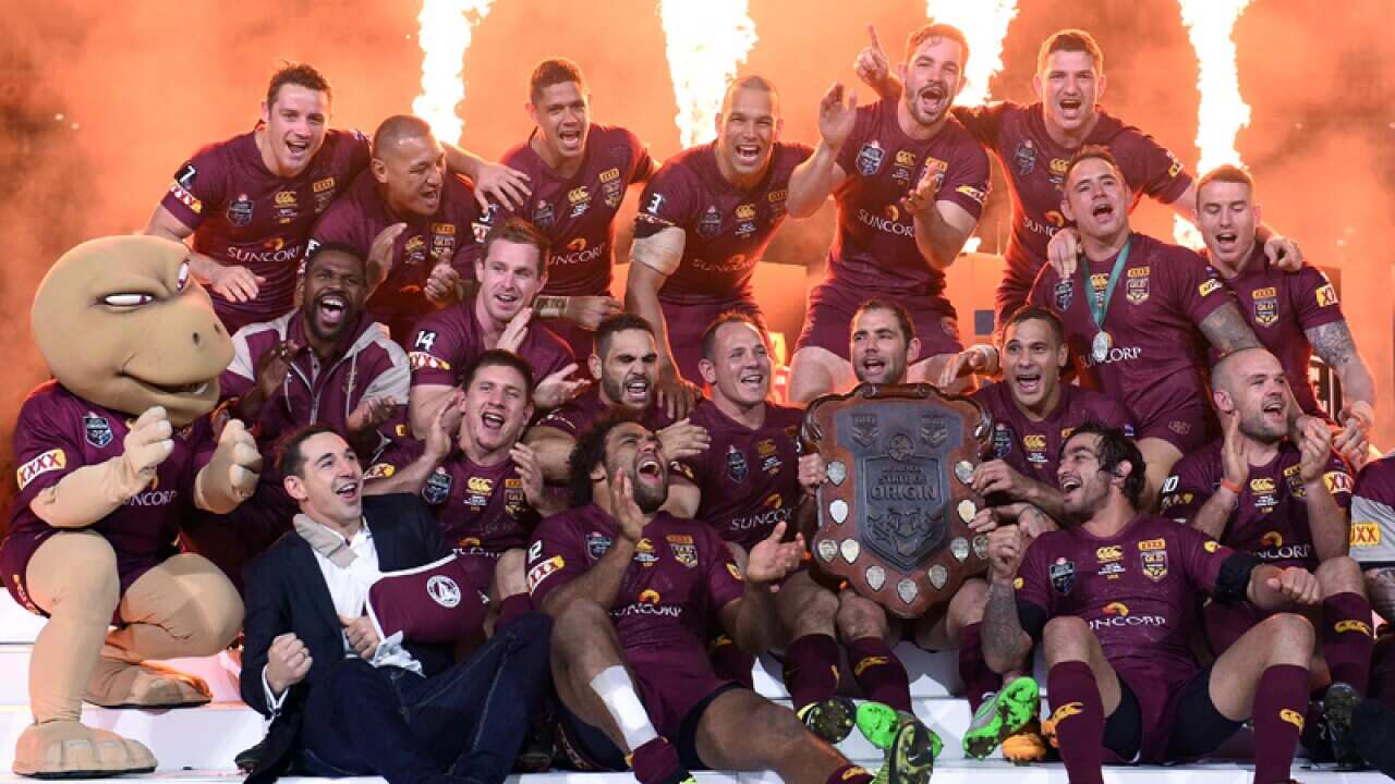 Queensland players celebrate following State of Origin Game III.