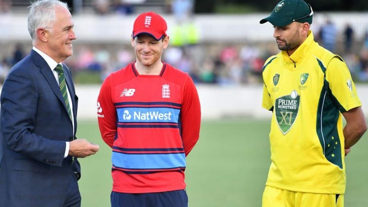 England captain Eoin Morgan (C) and PM XI captain Nathan Lyon