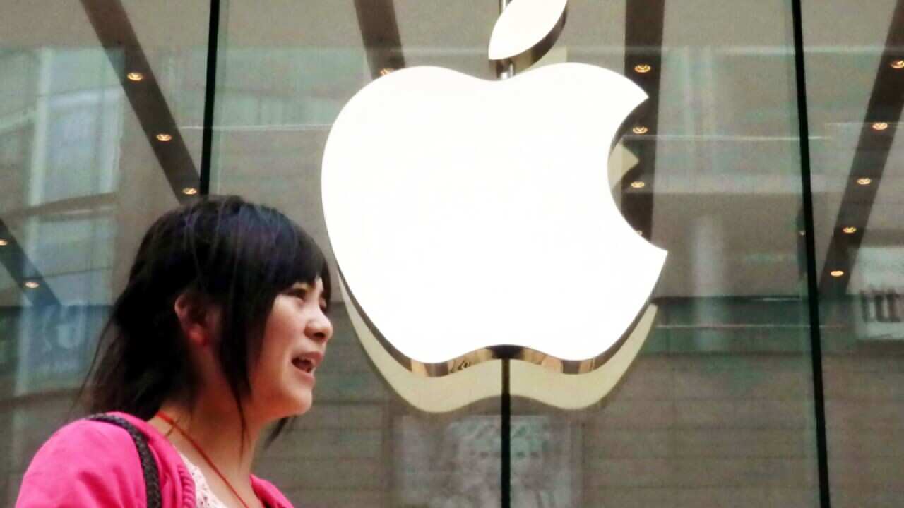 A pedestrian walks past the Apple Store in Shanghai, China