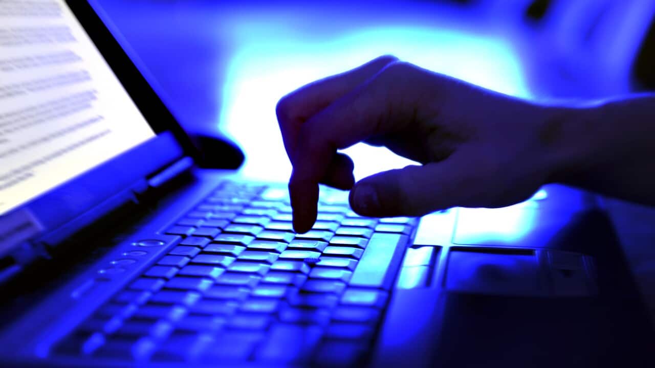 Close-up adult hand typing on laptop