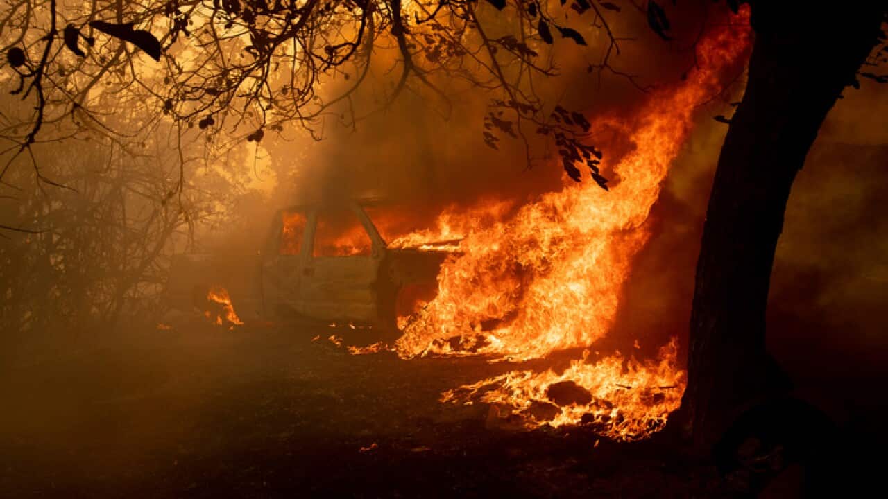 A pick-up truck burns as the River Fire tears through Lakeport, Calif., on Monday, July 30, 2018. (AP Photo/Noah Berger)