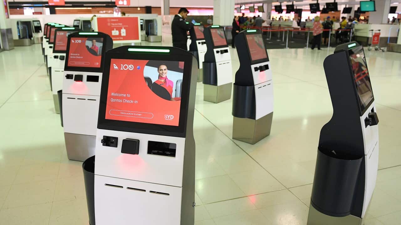 Deserted Qantas self-serve check-in kiosks at Sydney International Airport