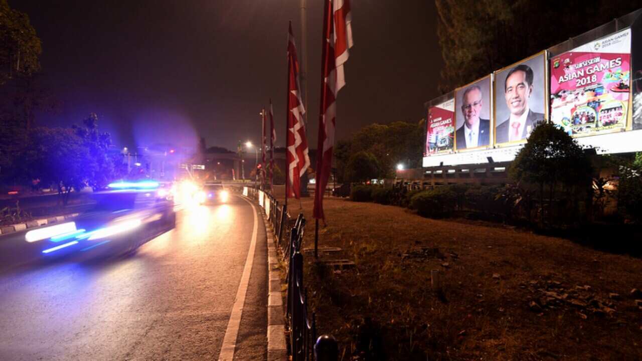 Posters of Prime Minister Scott Morrison and Indonesian President Joko Widodo near Halim International airport in Jakarta (AAP).