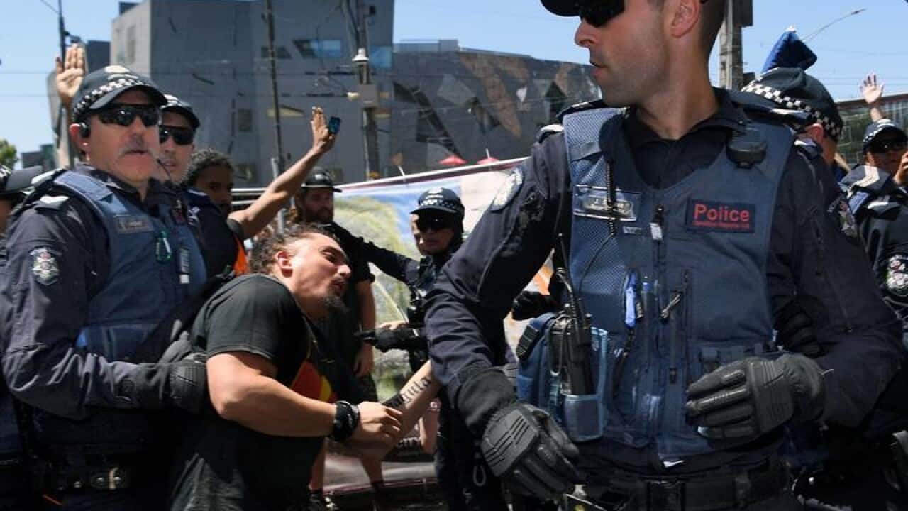 Victorian Police stop a fight between Australia Day protesters.