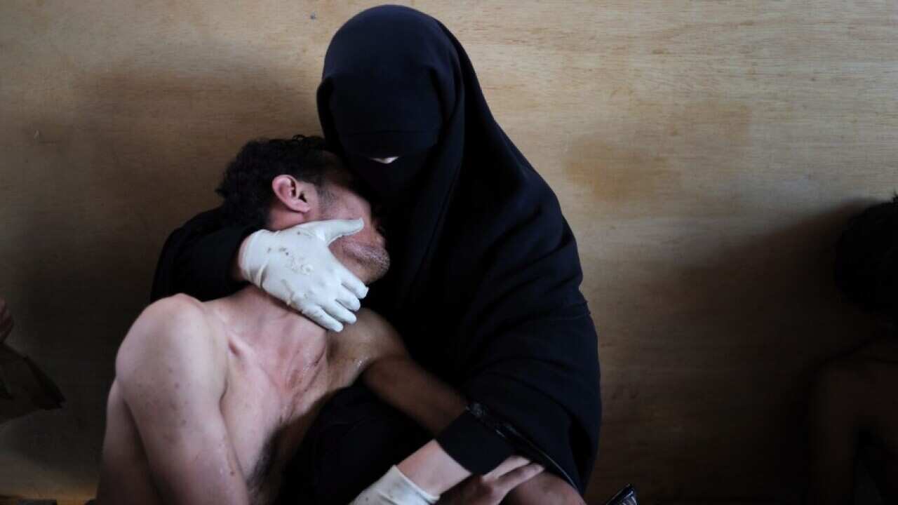 This picture by photographer Samuel Aranda of Spain is the World Press Photo of the Year 2011 in the 55th annual World Press Photo Contest, it was announced by the organizers on 10 February 2012 in Amsterdam, The Netherlands. A woman holds a wounded relat