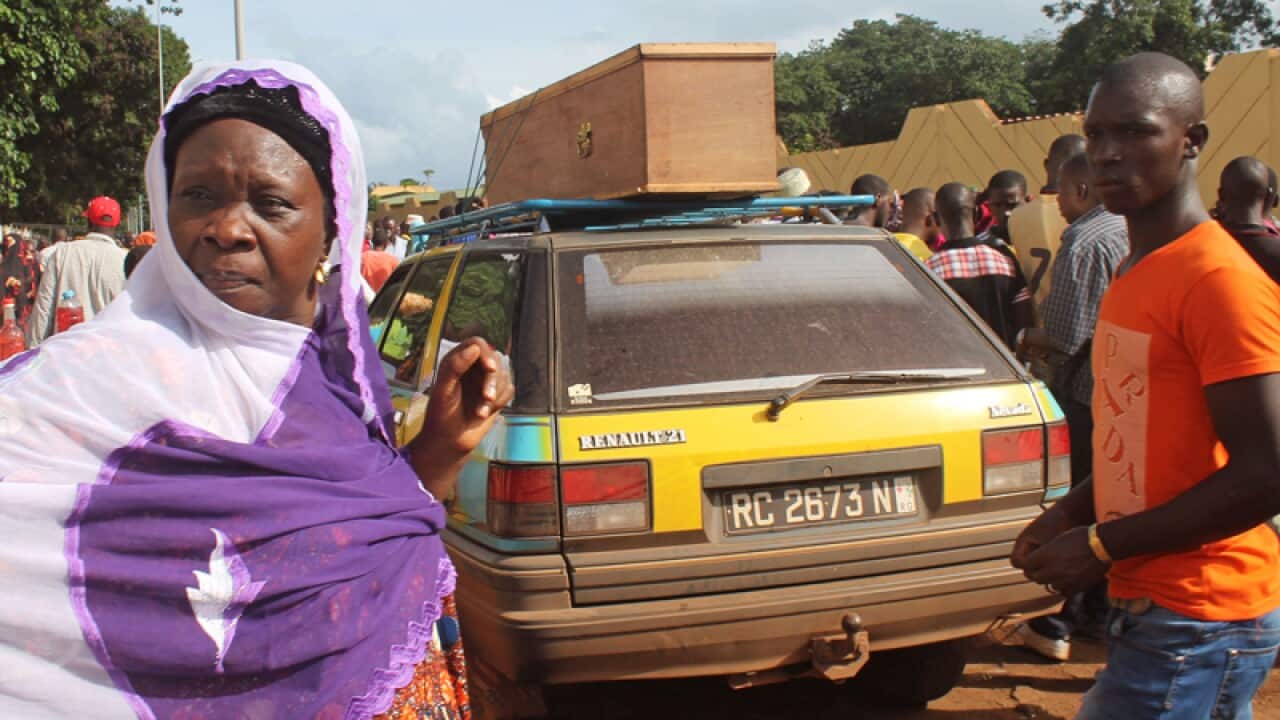 A casket containing the body of a victim of a stampede in Conakry