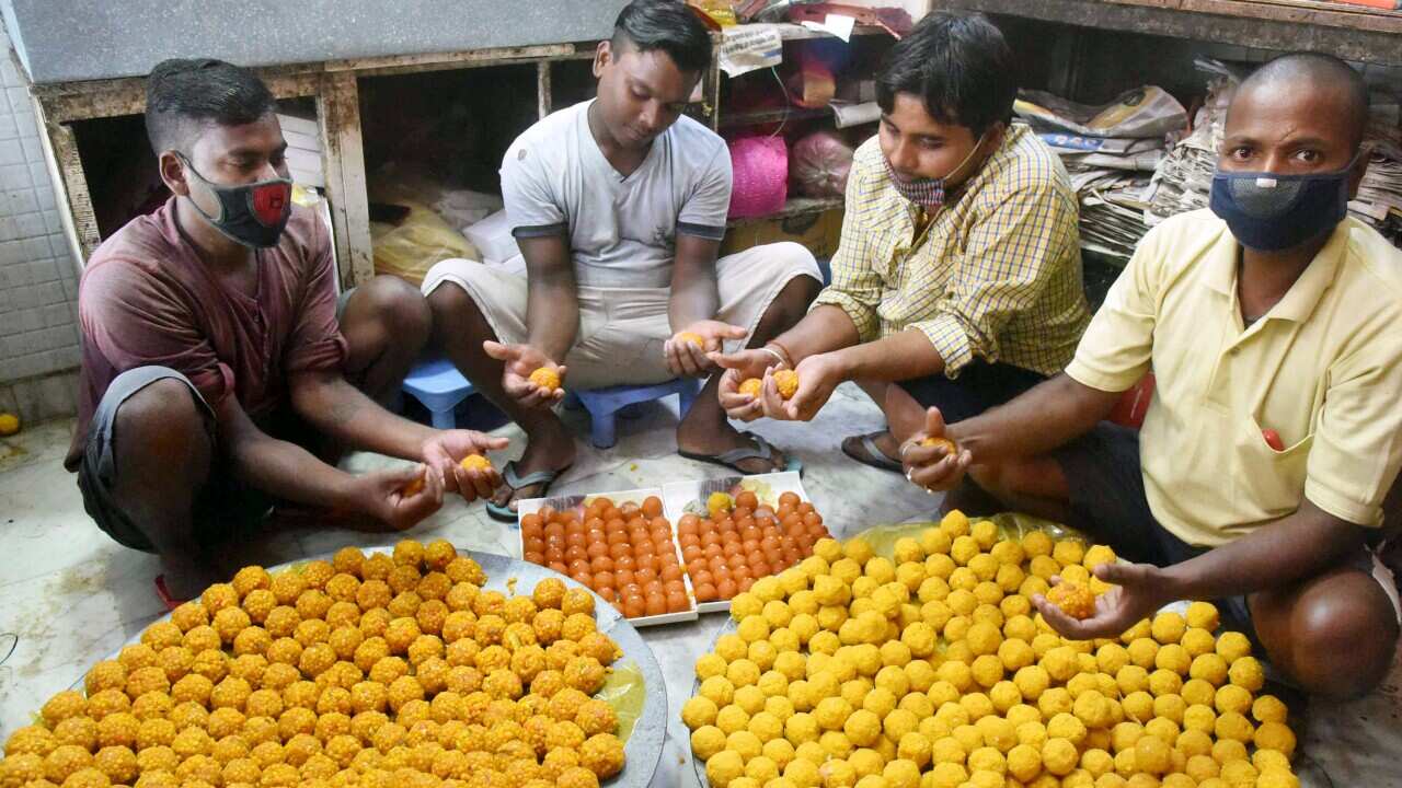 Workers prepare sweets for distribution, ahead of the counting for Bihar Assembly Elections
