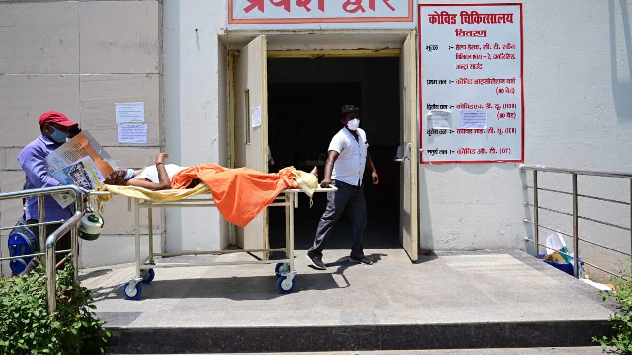 Family members and medical workers shift a coronavirus patient to Level-3 ward of Swaroop Rani Nehru hospital in Prayagraj, India.