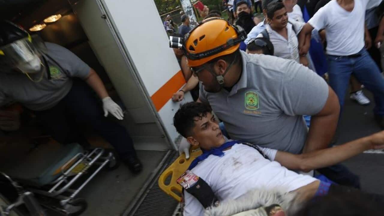 A man who was shot is loaded into an ambulance