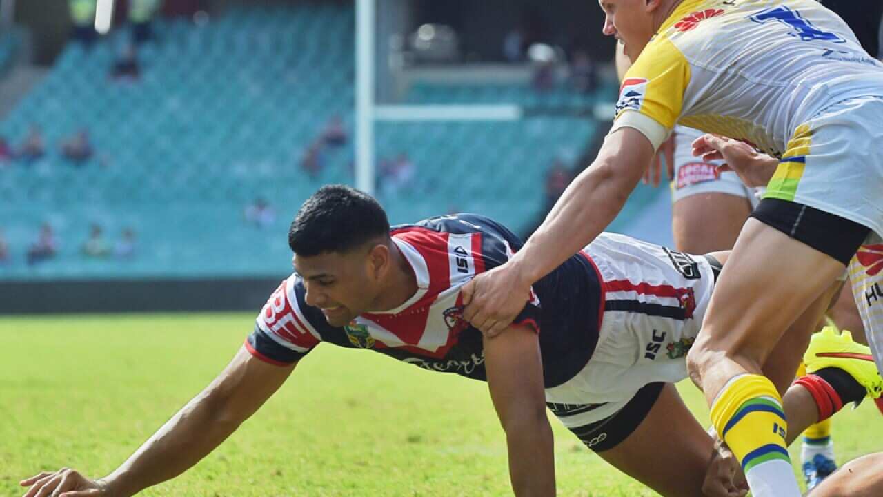 Roosters player Daniel Tupou scores a try.