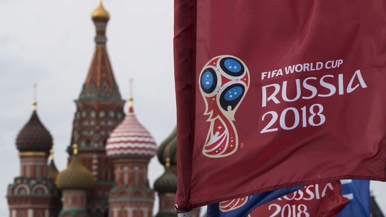 A flag with the logo of the World Cup 2018 on display with the St. Basil's Cathedral in the background, in Moscow, Russia, Monday, June 4, 2018. (AP Photo/Pavel Golovkin)