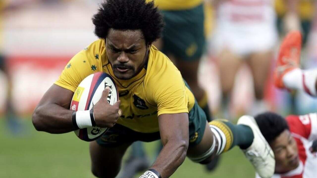 Henry Speight of Australia scores a try against Japan.