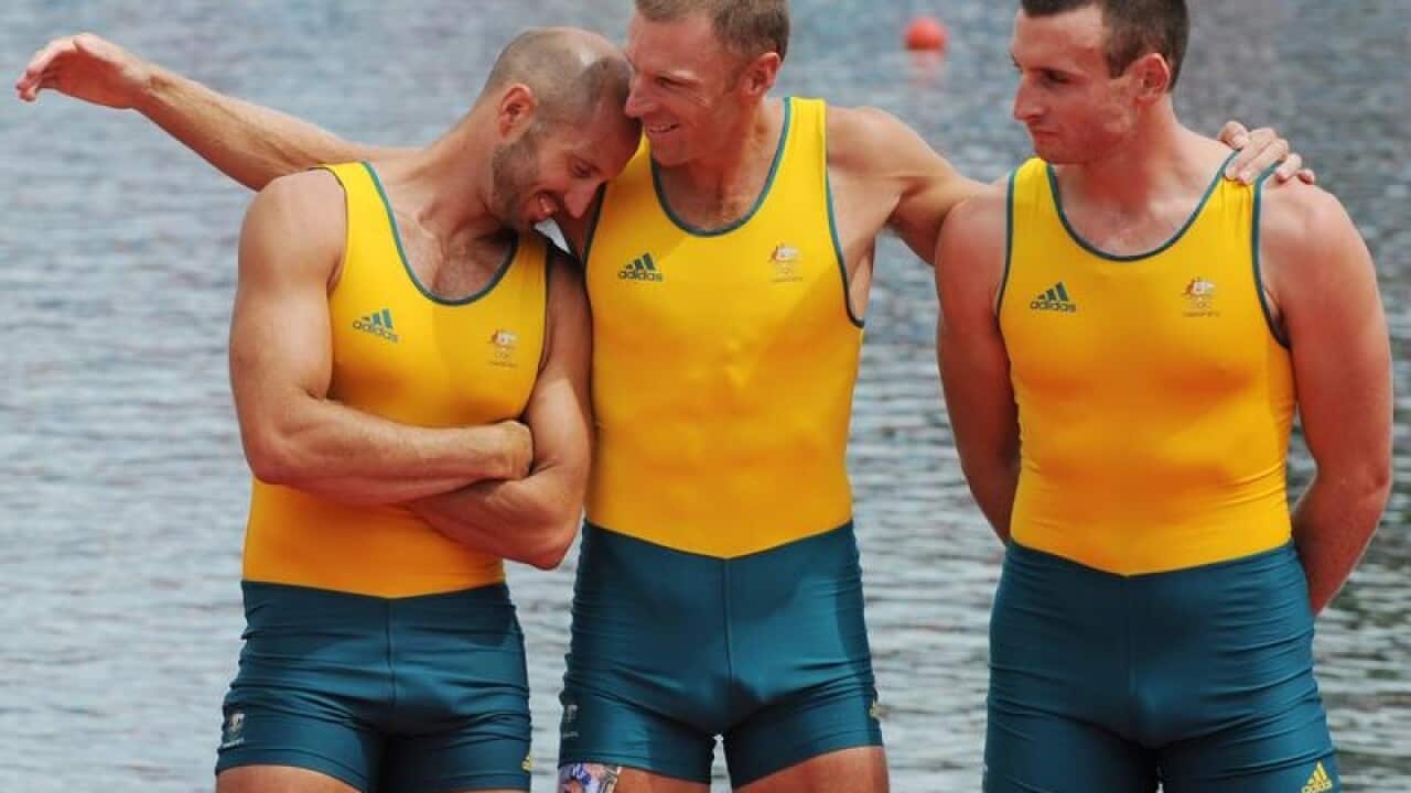 Rower James Capman (centre) embraced by fellow teammates