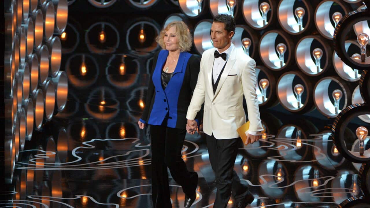 Kim Novak, left, and Matthew McConaughey walk on stage at the Oscars