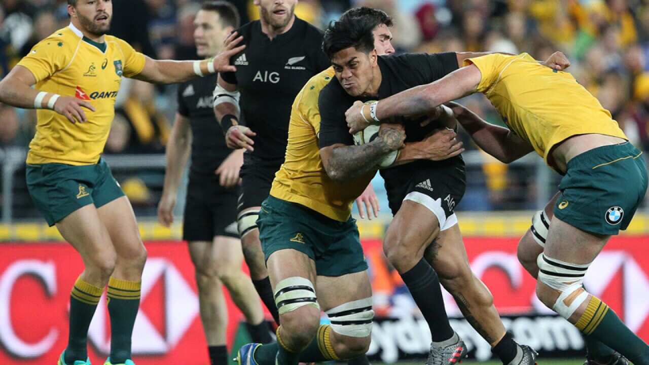 New Zealand's Julian Savea powers through the Australian defence