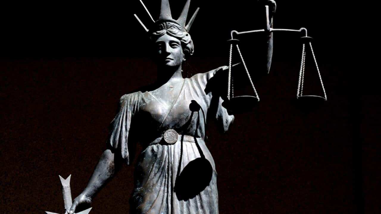 a statue of 'Lady Justice' outside the Supreme Court in Brisbane