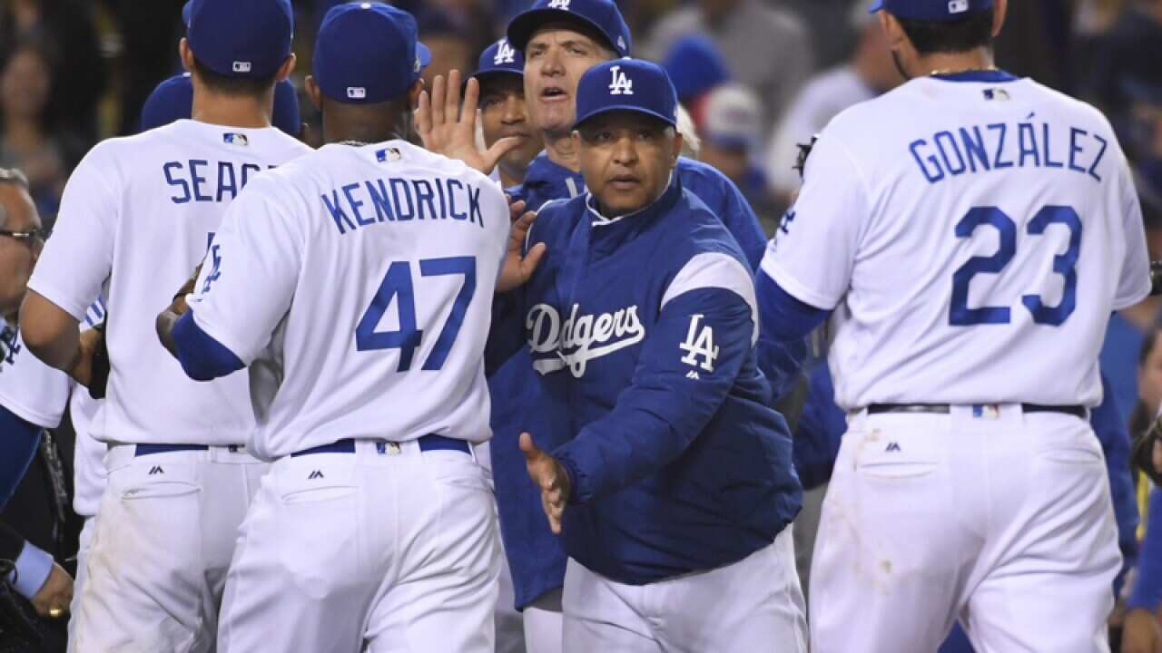 Los Angeles Dodgers manager Dave Roberts congratulates players