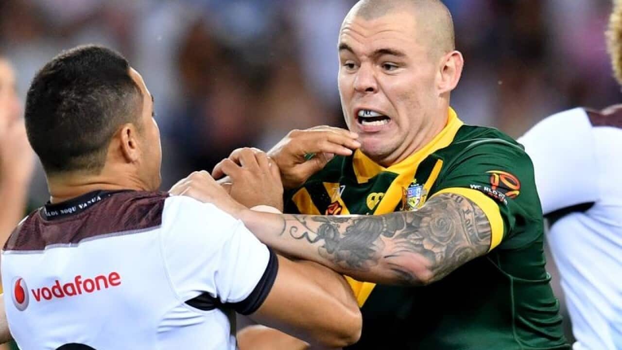 Jarryd Hayne is knocked flying after kicking the ball by David Klemmer