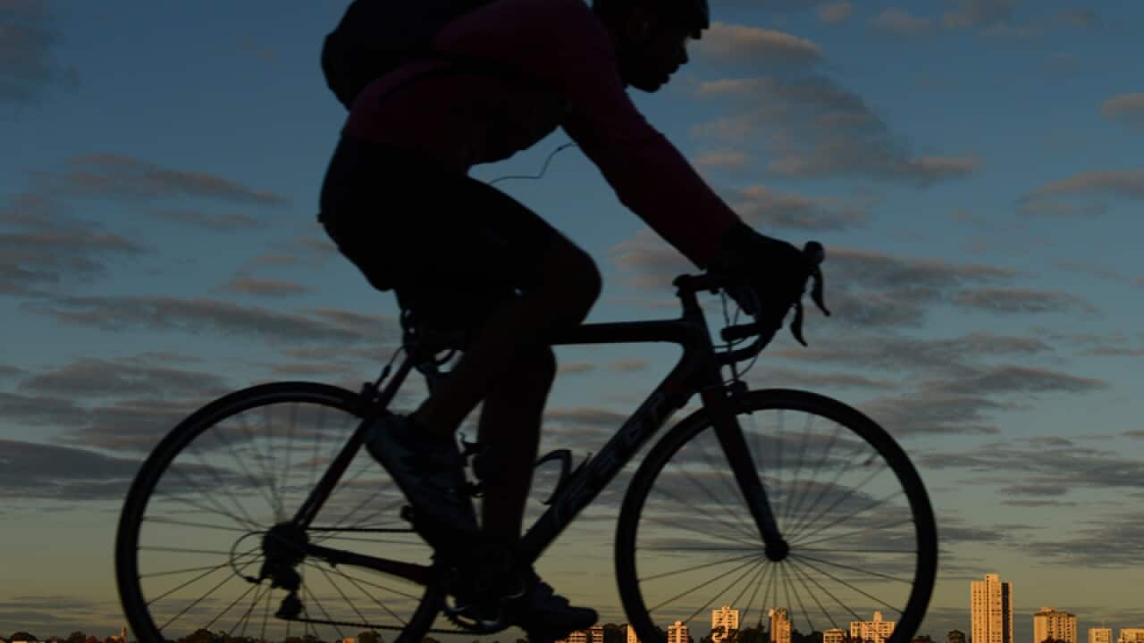 A bicycle rider rides around the Swan River in Perth