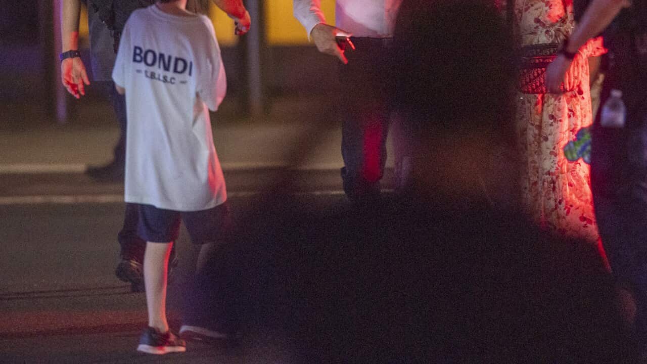 A group of people running on a beach.