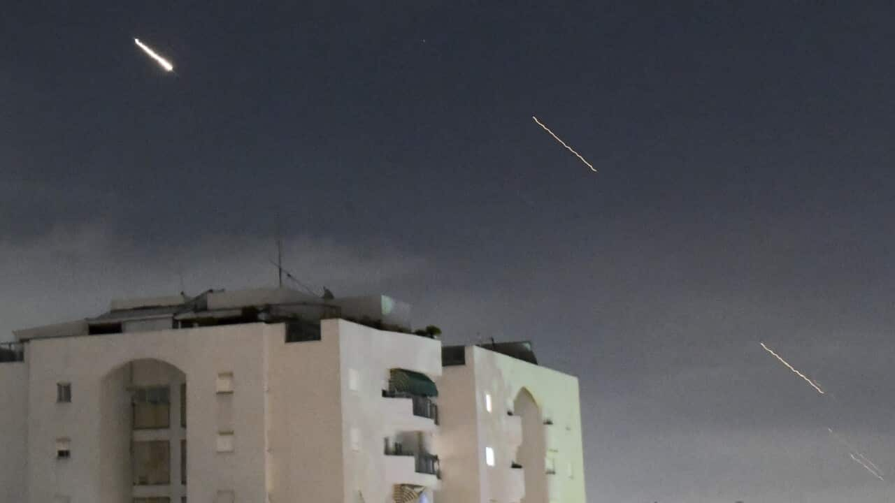 Streaks of light above buildings