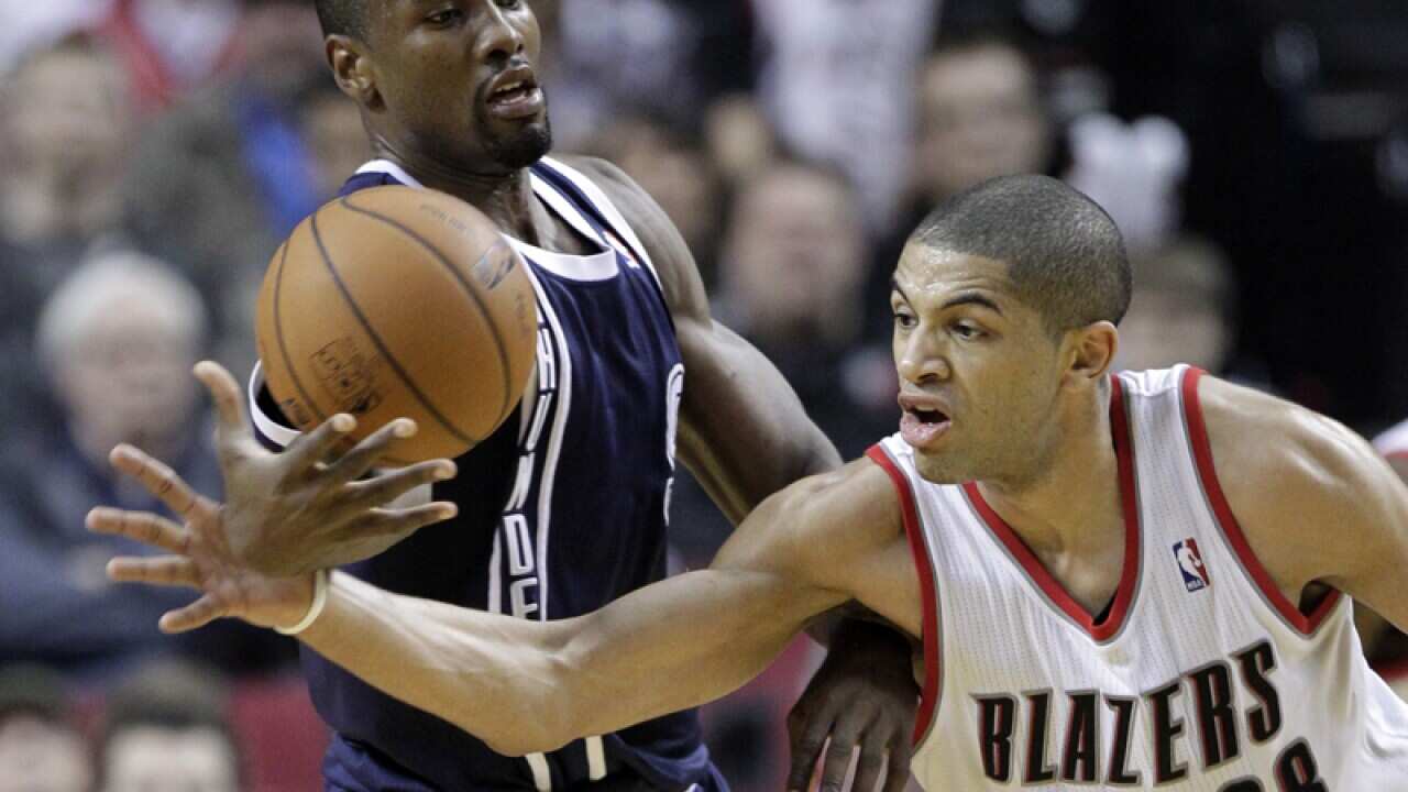 Oklahoma City Thunder's Serge Ibaka (L) with Portland's Nicolas Batum