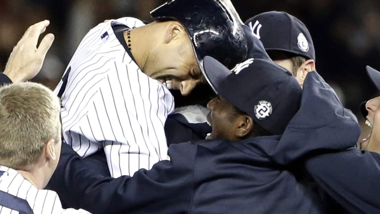 New York's Derek Jeter (C) celebrates after his game winning hit