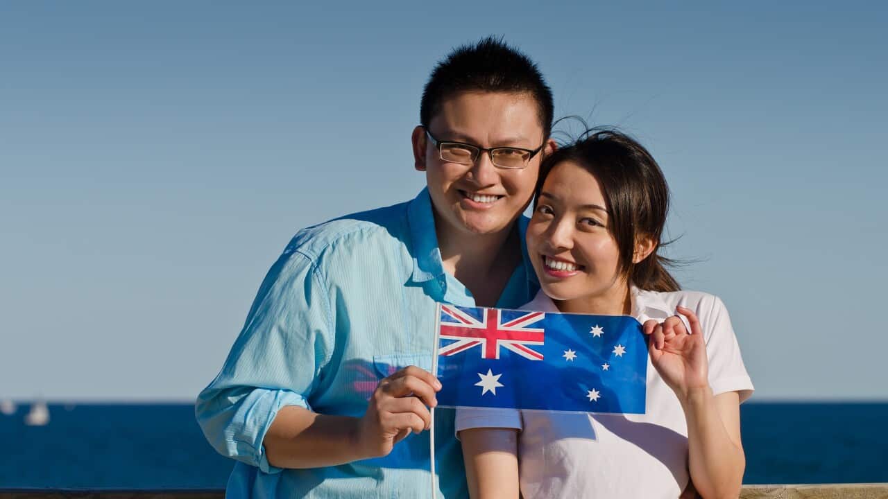 Aussie Asian couple with Australian flag