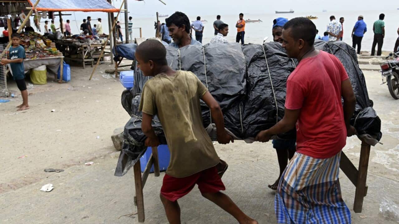 Locals remove small shops near a Bangladesh beach
