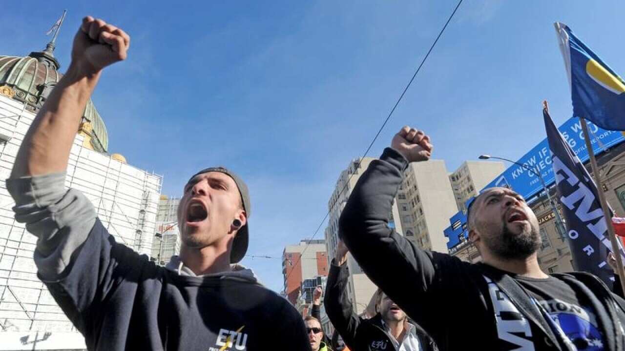 Image of Building and construction workers marching.