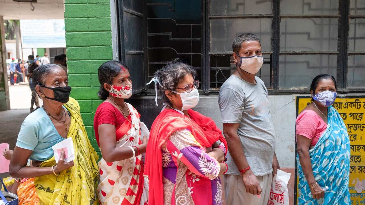 People stand in a queue for coronavirus testing at Madhyamgram rural hospital (AAP)