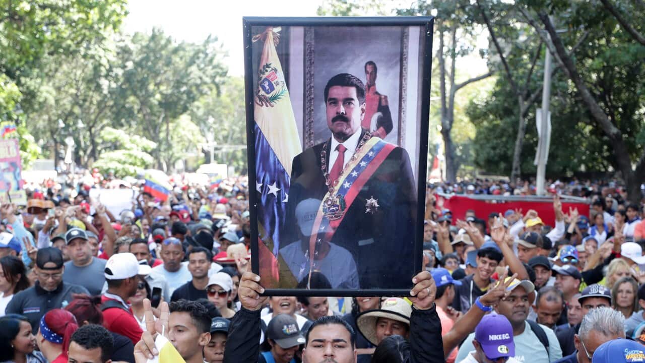 A man holds a picture of the captured President of Venezuela, Nicolas Maduro, during a march in support of the start of the National Assembly in Caracas, Venezuela, 05 January 2026.