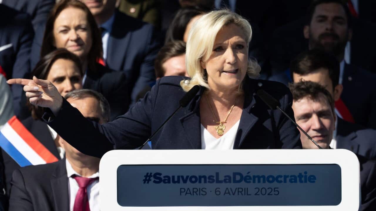Marine Le Pen speaks on stage as she attends a rally in her support (AAP)