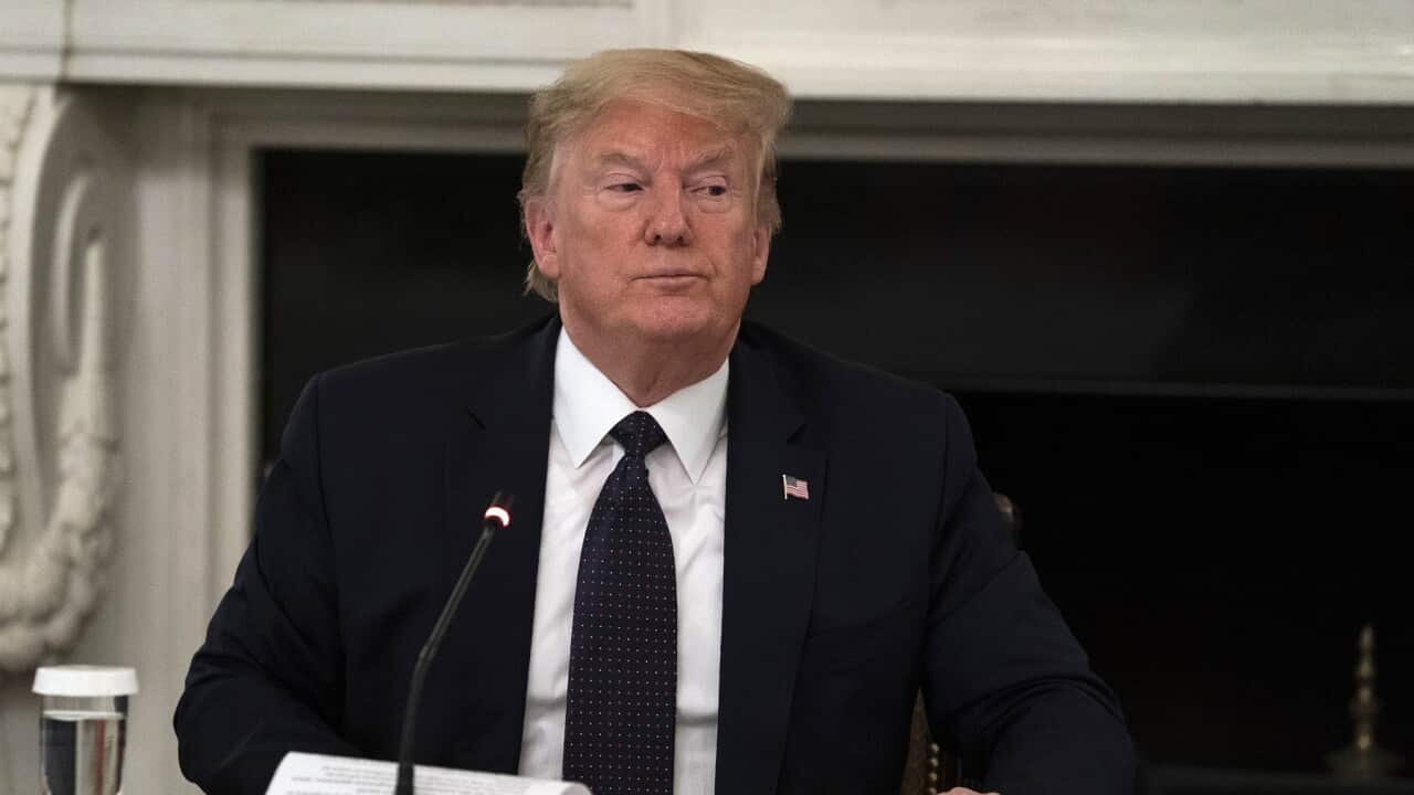 President Donald Trump gets up at the conclusion of a meeting with restaurant industry executives about the coronavirus response, in the State Dining Room of the White House, Monday, May 18, 2020, in Washington. (AP Photo/Evan Vucci)