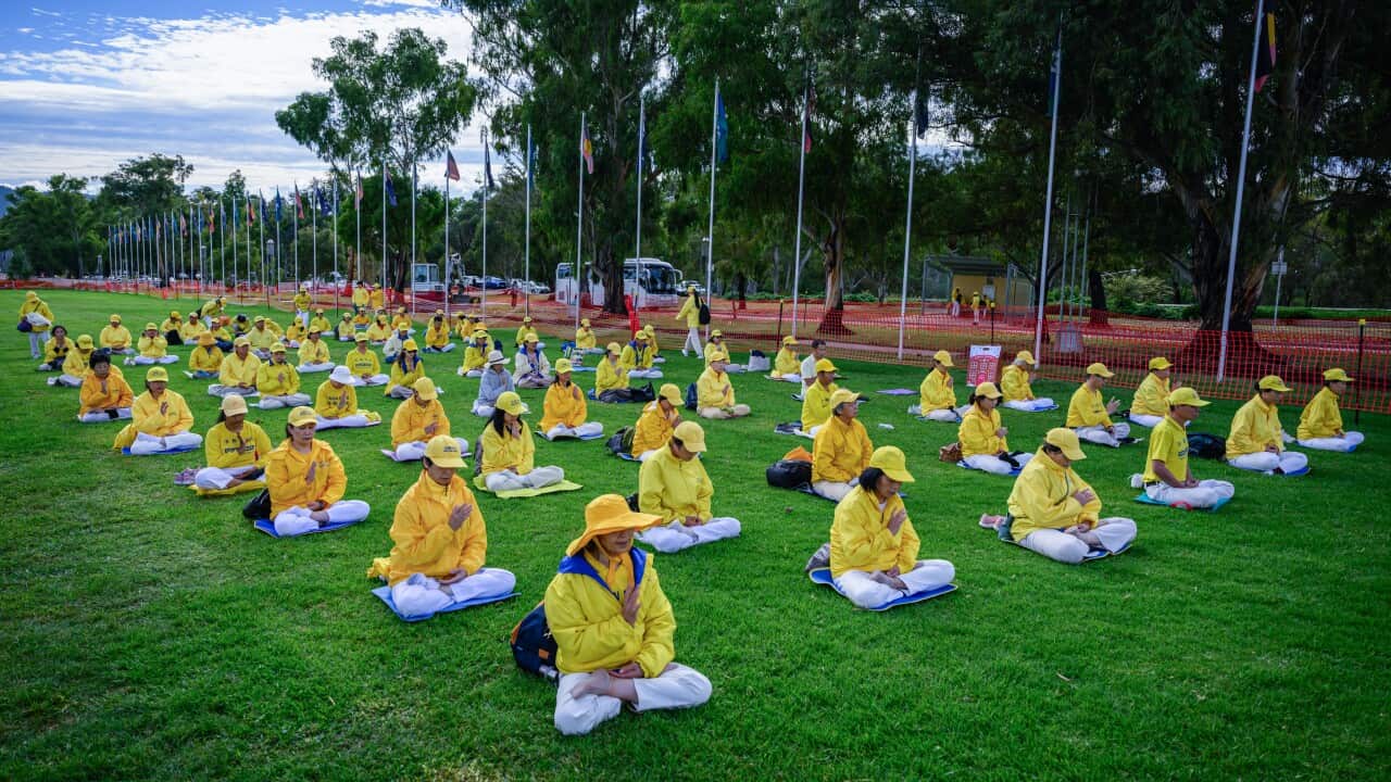 People seated on a lawn.