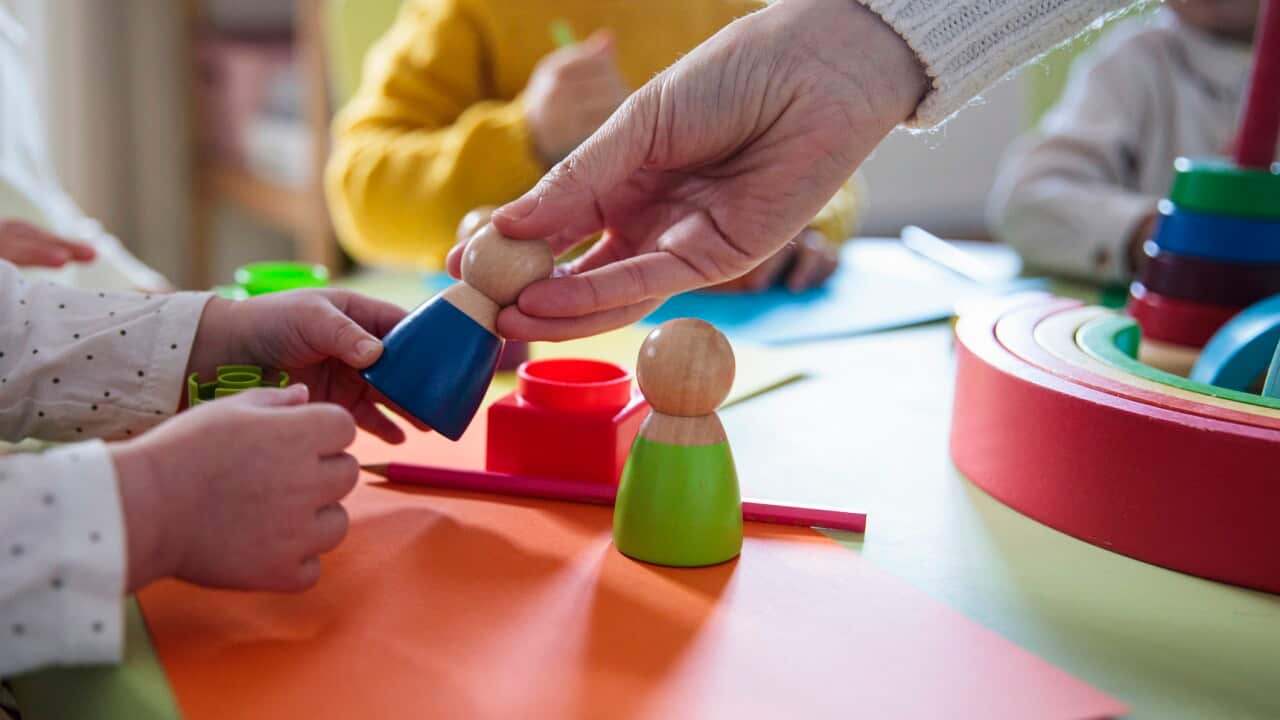 Preschool children playing with colorful shapes