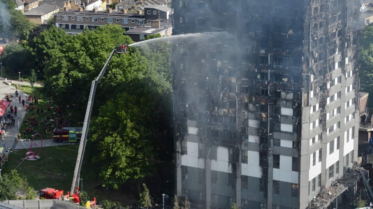 Firefighters spray water after a fire engulfed the 24-storey Grenfell Tower in west London.. Picture date: Wednesday June 14, 2017.