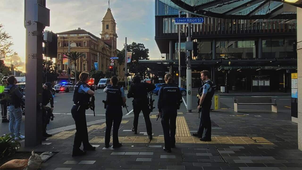 Armed police officers standing on a street